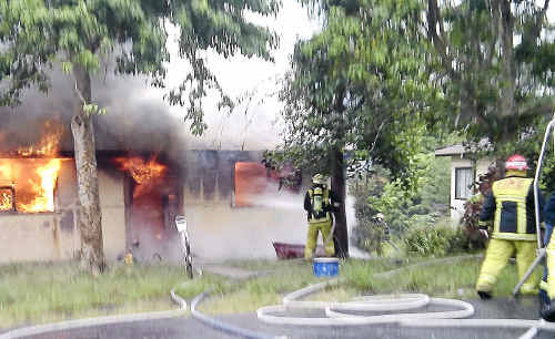 The male occupant of this Park Beach home could only look on as flames took hold of the family home on Saturday morning. The male occupant of this Park Beach home could only look on as flames took hold of the family home on Saturday morning.